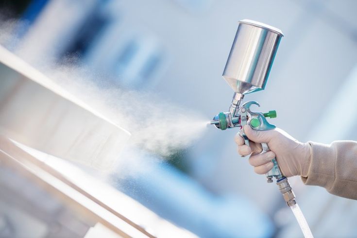 Expert spray finishes — HVLP spray gun applying finish